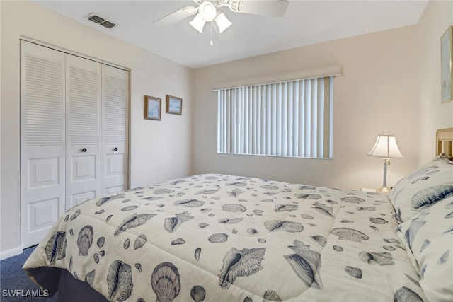 carpeted bedroom with ceiling fan and a closet