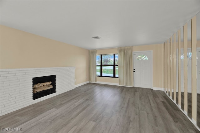 unfurnished living room with a fireplace and wood-type flooring