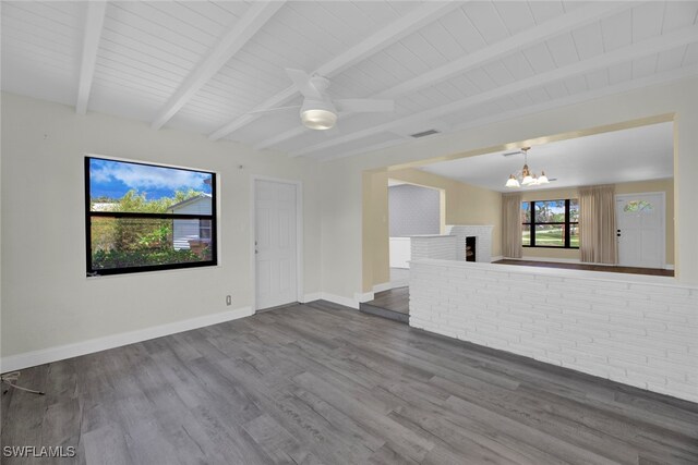 unfurnished living room featuring wood-type flooring, a fireplace, beam ceiling, wood ceiling, and ceiling fan with notable chandelier