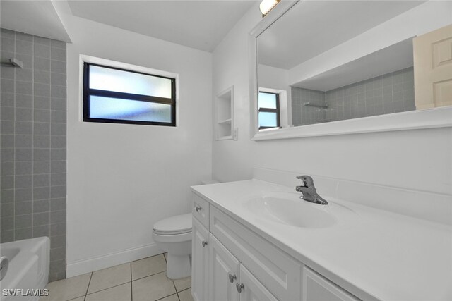 full bathroom featuring toilet, vanity, tile patterned flooring, and plenty of natural light