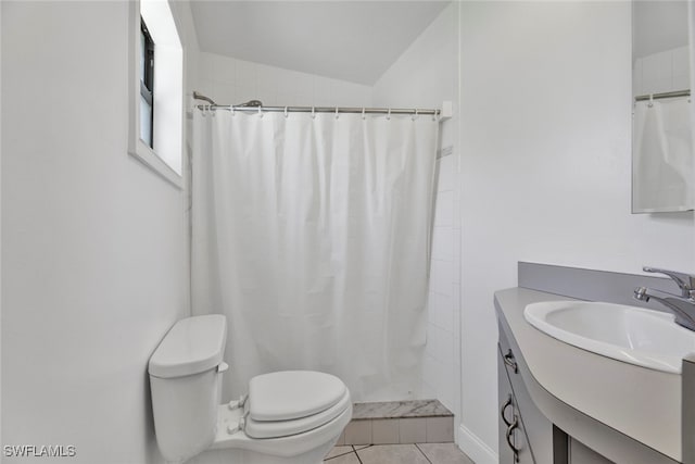 bathroom with tile patterned floors, a shower with curtain, vanity, vaulted ceiling, and toilet