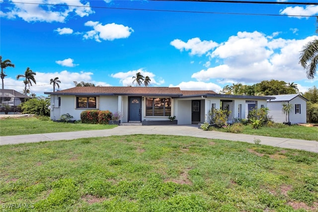 ranch-style home with a front lawn