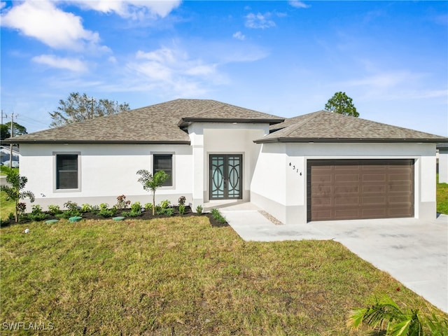 view of front facade with a garage and a front yard