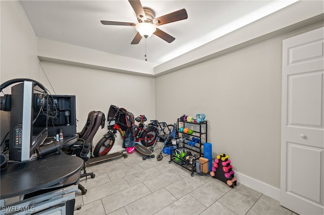 workout room featuring light tile patterned floors and ceiling fan