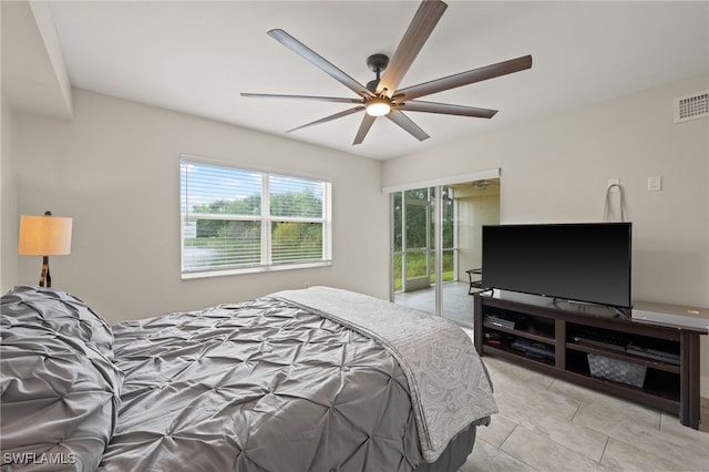 tiled bedroom featuring ceiling fan