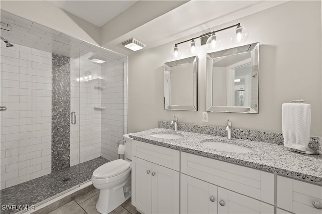 bathroom with walk in shower, toilet, vanity, and tile patterned floors