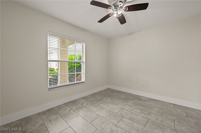 spare room featuring light tile patterned floors and ceiling fan