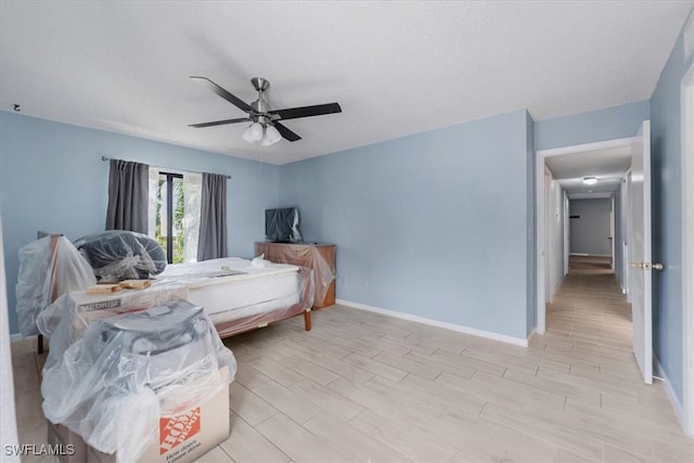 bedroom featuring light hardwood / wood-style flooring and ceiling fan