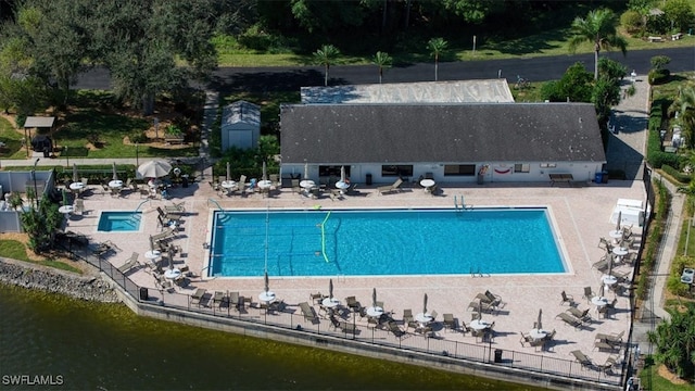 view of pool featuring a patio area and a water view