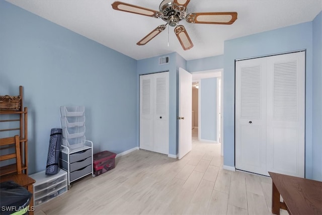 bedroom with light wood-type flooring, ceiling fan, and a closet