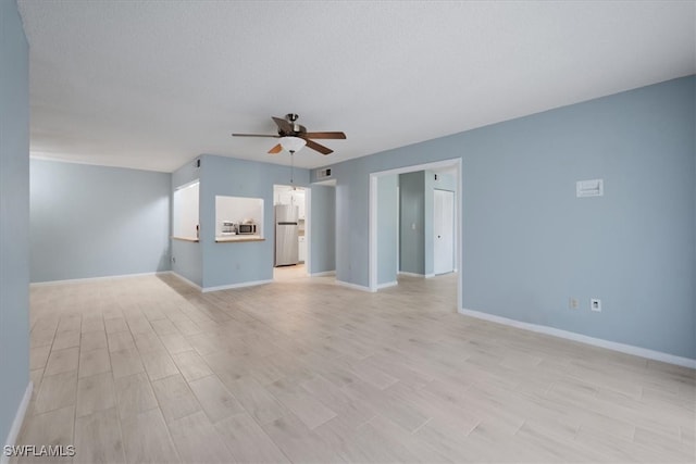 unfurnished living room featuring a textured ceiling, ceiling fan, and light hardwood / wood-style flooring