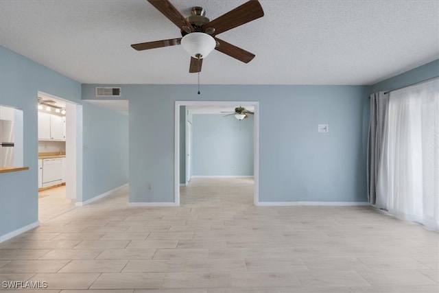 unfurnished room featuring a textured ceiling and ceiling fan