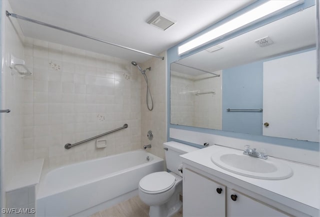 full bathroom featuring vanity, toilet, and tiled shower / bath