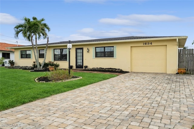 ranch-style home with a garage and a front yard