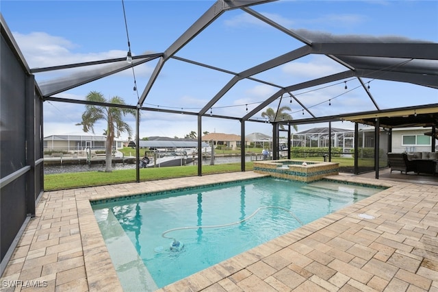 view of swimming pool featuring a patio, a water view, a lanai, and an in ground hot tub