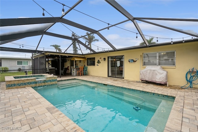 view of swimming pool featuring a patio, a lanai, and an in ground hot tub