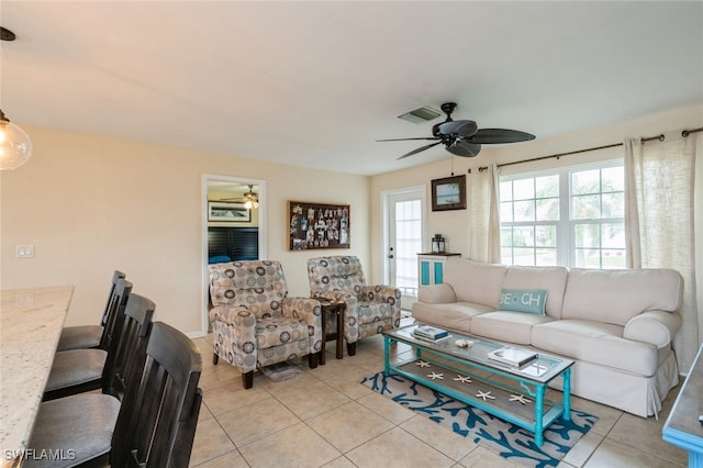 tiled living room featuring ceiling fan