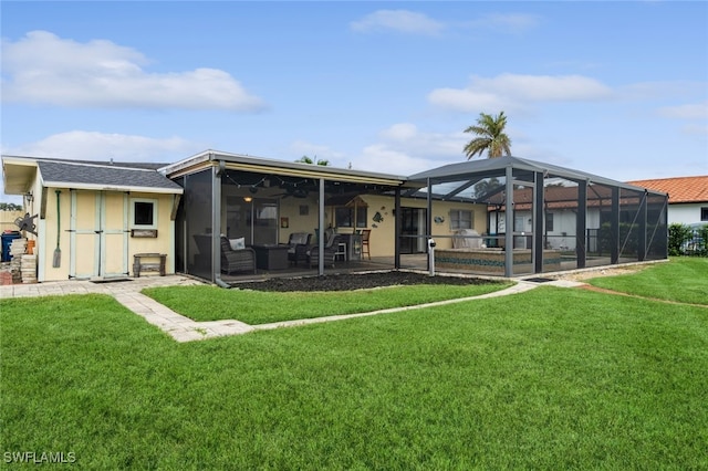 rear view of property featuring a lanai, a yard, and a patio area