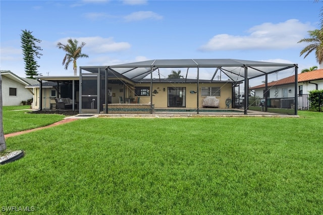 back of house with a patio, a lanai, and a yard