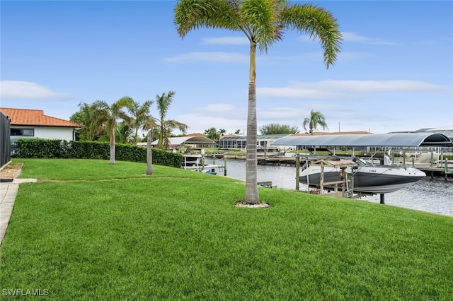 view of yard featuring a water view and a boat dock