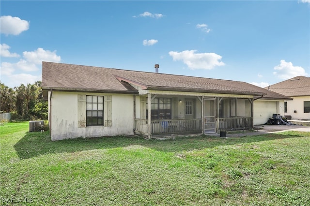 view of front facade featuring central AC unit, a sunroom, and a front lawn