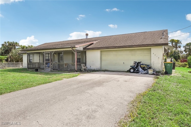 ranch-style home with a front yard, a garage, and covered porch