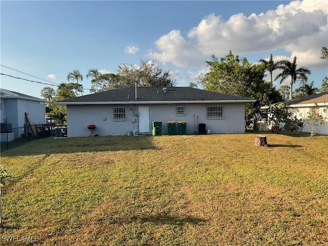 back of property featuring a yard