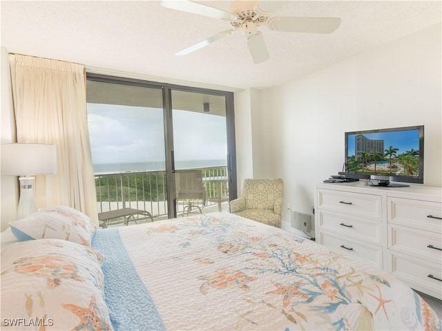 bedroom with expansive windows, ceiling fan, a textured ceiling, and access to outside