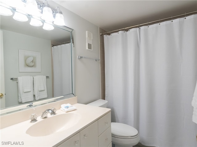 bathroom featuring toilet and vanity