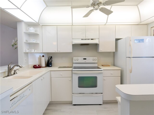 kitchen featuring white appliances, white cabinetry, sink, and light hardwood / wood-style floors