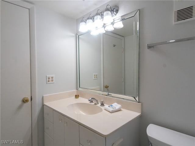 bathroom with vanity and toilet