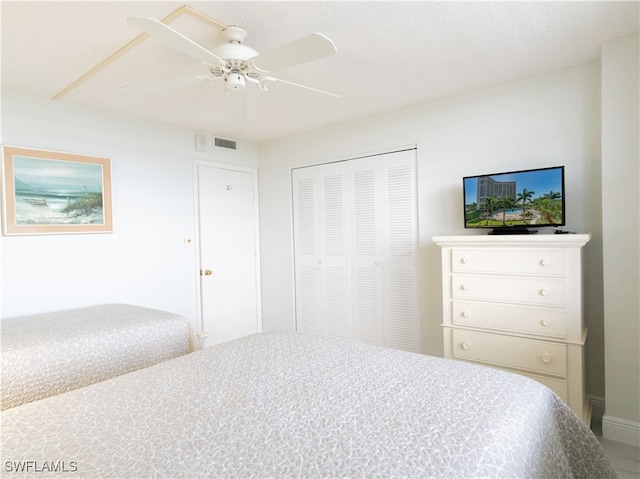 bedroom with ceiling fan and a closet