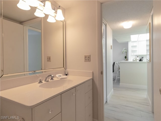 bathroom featuring vanity, a textured ceiling, and hardwood / wood-style floors