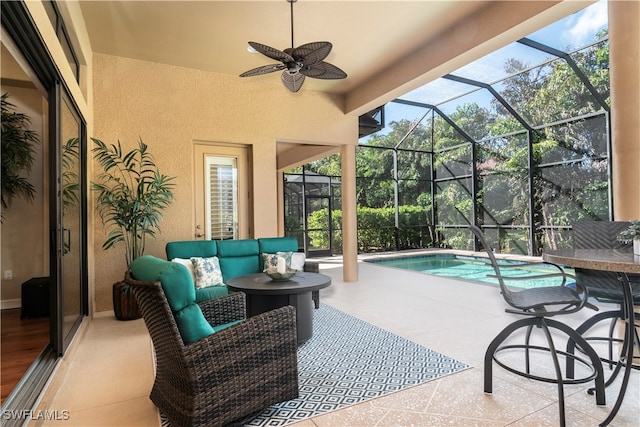 view of patio with glass enclosure, an outdoor living space, and ceiling fan