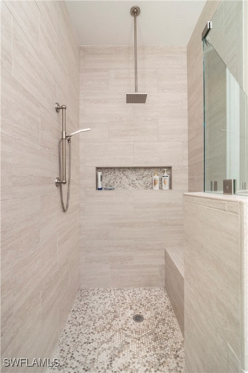 bathroom with a tile shower