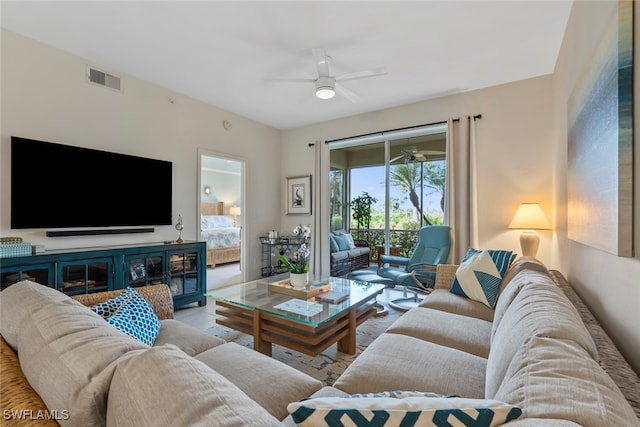 living room featuring light hardwood / wood-style flooring and ceiling fan