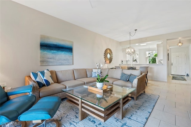 living room featuring light tile patterned floors and a chandelier