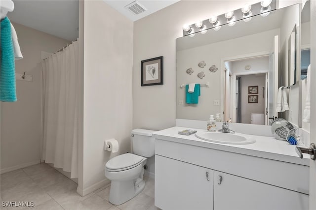 bathroom with tile patterned flooring, vanity, and toilet