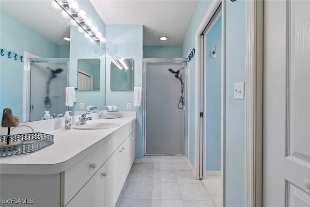 bathroom with tile patterned flooring, vanity, and a shower with shower door