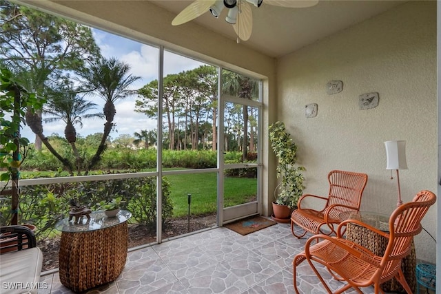 sunroom / solarium featuring ceiling fan