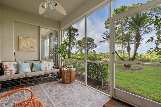 sunroom / solarium featuring plenty of natural light and ceiling fan