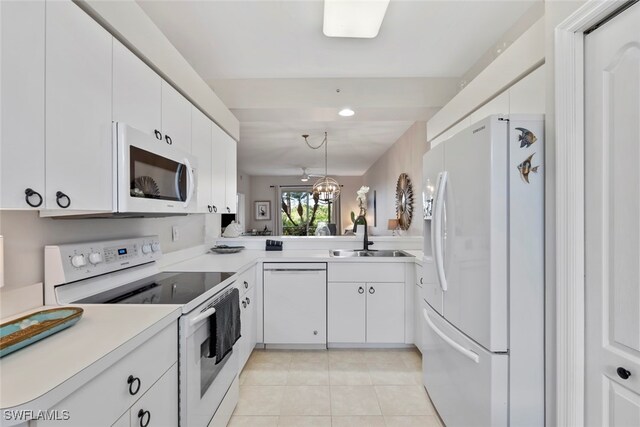 kitchen with white cabinets, pendant lighting, white appliances, and sink