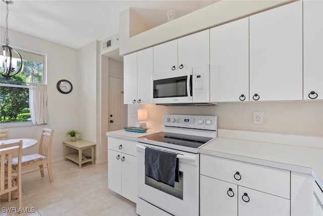 kitchen featuring pendant lighting, white appliances, an inviting chandelier, and white cabinetry