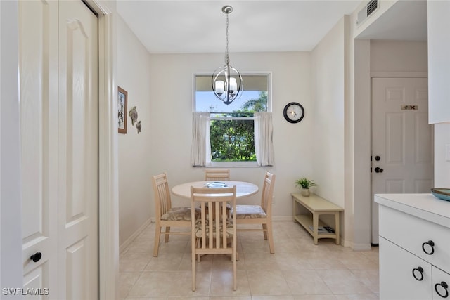 tiled dining space with an inviting chandelier