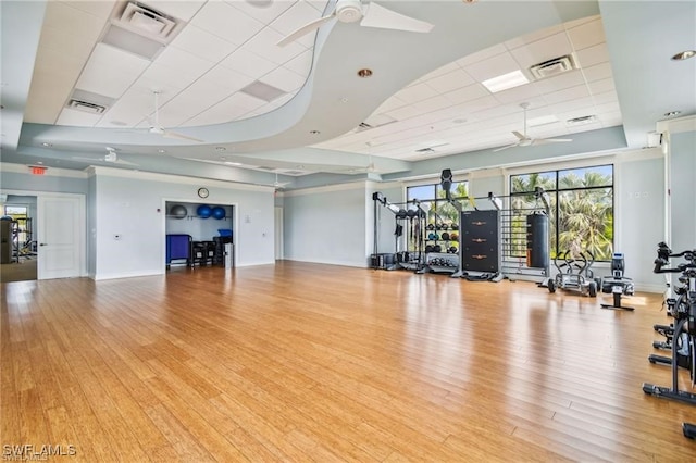 gym with light wood-type flooring and ceiling fan