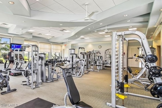 gym with a paneled ceiling and ceiling fan