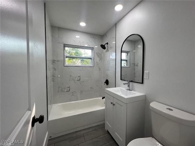 full bathroom featuring vanity, toilet, and tiled shower / bath