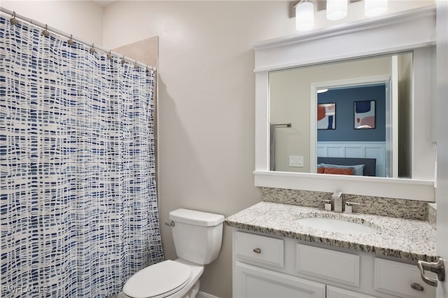 bathroom with vanity, toilet, and a shower with curtain