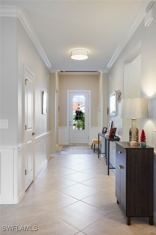 entryway featuring crown molding and light tile patterned flooring