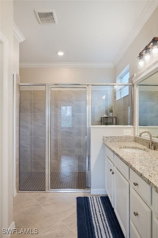 bathroom with crown molding, tile patterned flooring, vanity, and a shower with shower door